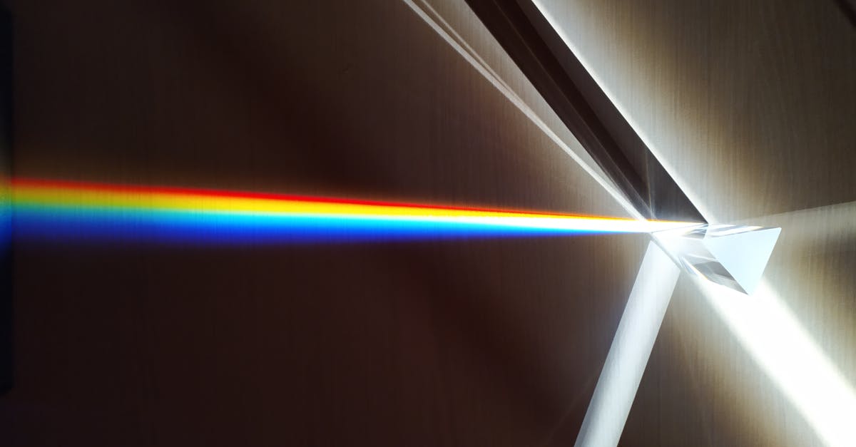 A colorful spectrum of light refracted through a glass prism creating a rainbow effect.